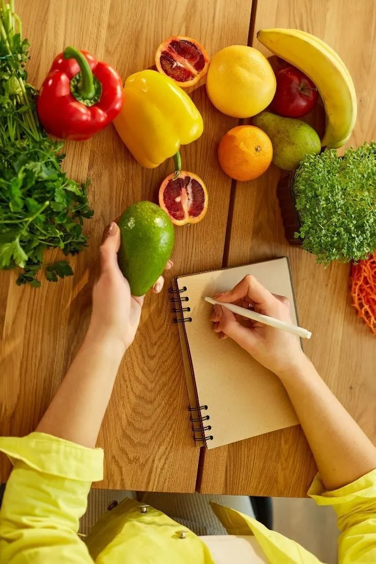 Notebook with simple meal planning notes on a linen surface